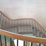 sweeping oak handrial and metal balusters on round staircase