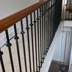 bespoke metal spindles and continous Oak handrail on stone stair